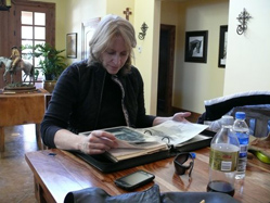 Sandy Gray looking through photo albums for archival shots