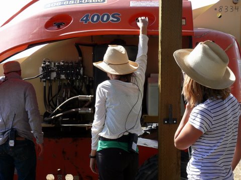 Luke Geissbuhler, Nicole Karczewski, and Becky DiLallo troubleshooting cherry picker